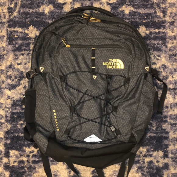 black and gold north face backpack
